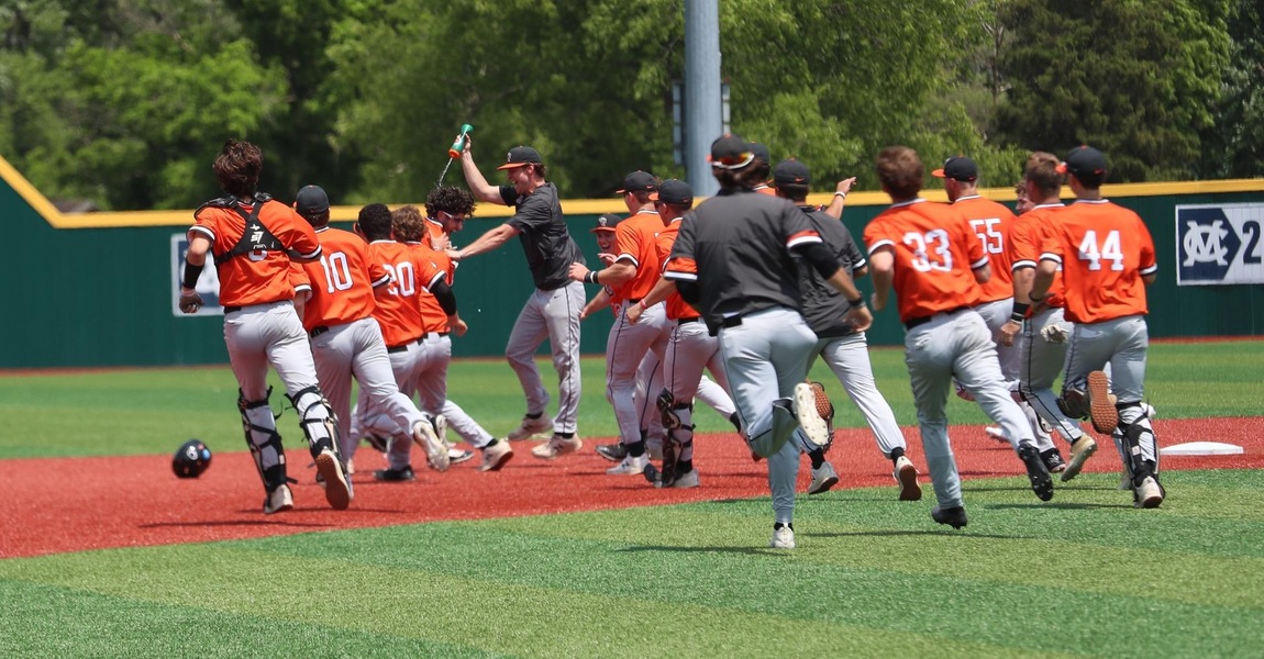 Kalamazoo College baseball players celebrating on the field after a walk-off win.