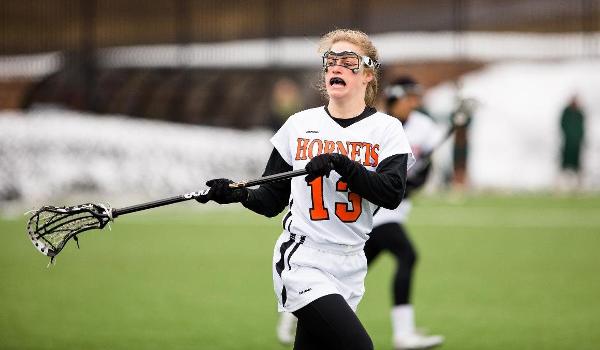 Anika Sproull playing lacrosse.
