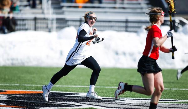 Clare Jensen playing lacrosse.