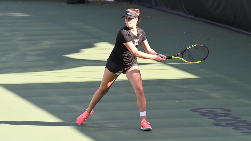 Caroline Norton playing tennis.