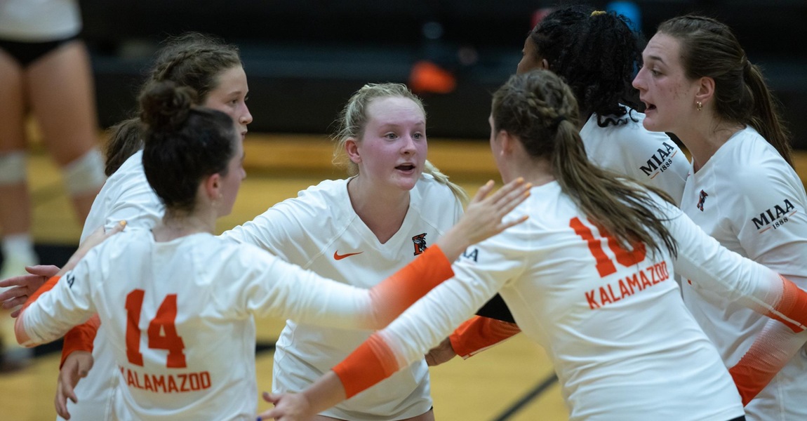Kalamazoo College volleyball players in a huddle.