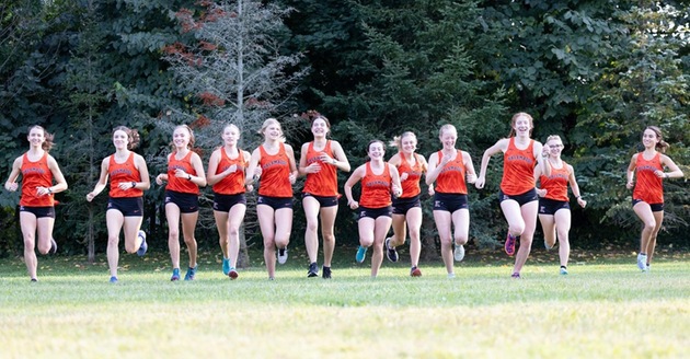 The Kalamazoo College women's cross country team warming up before a race.