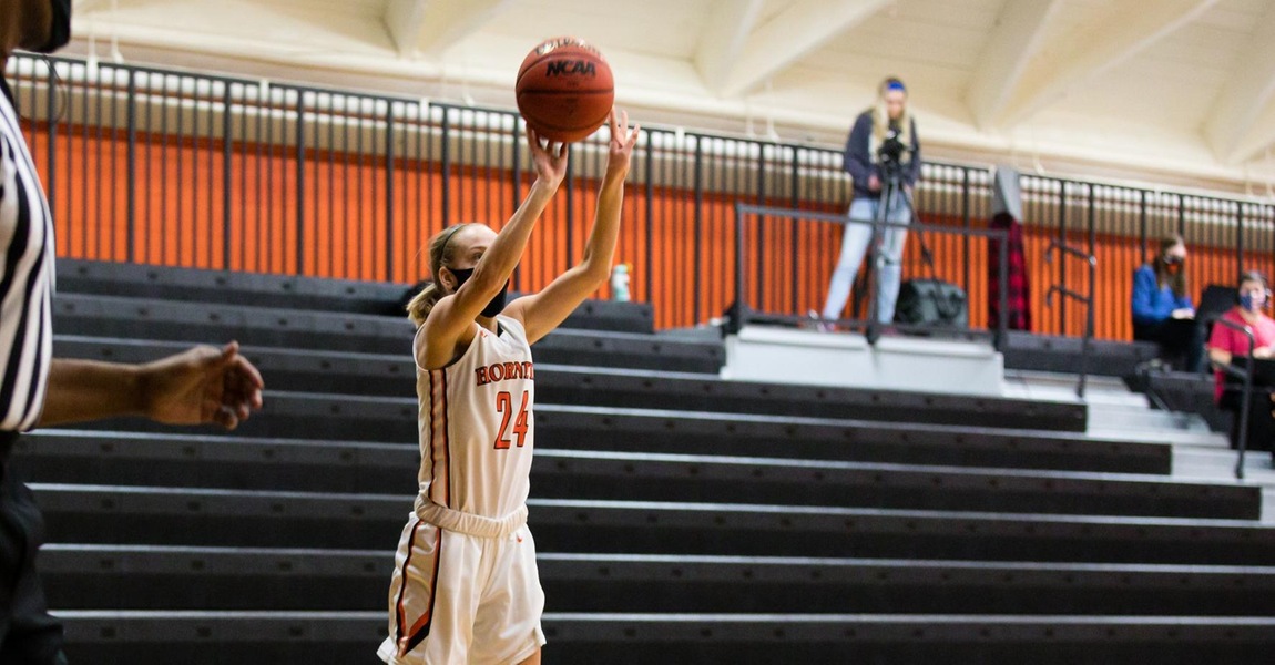 Isabelle Clark shooting a basketball.