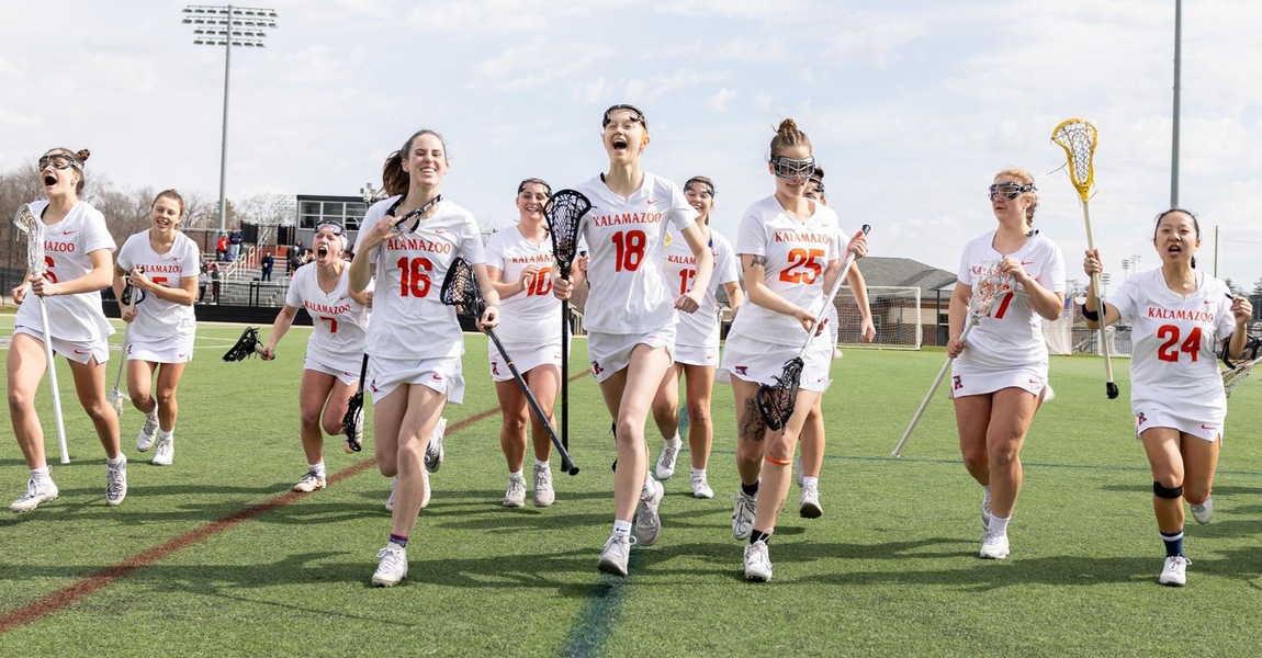 The women's lacrosse team is running off the field to prepare for the game.