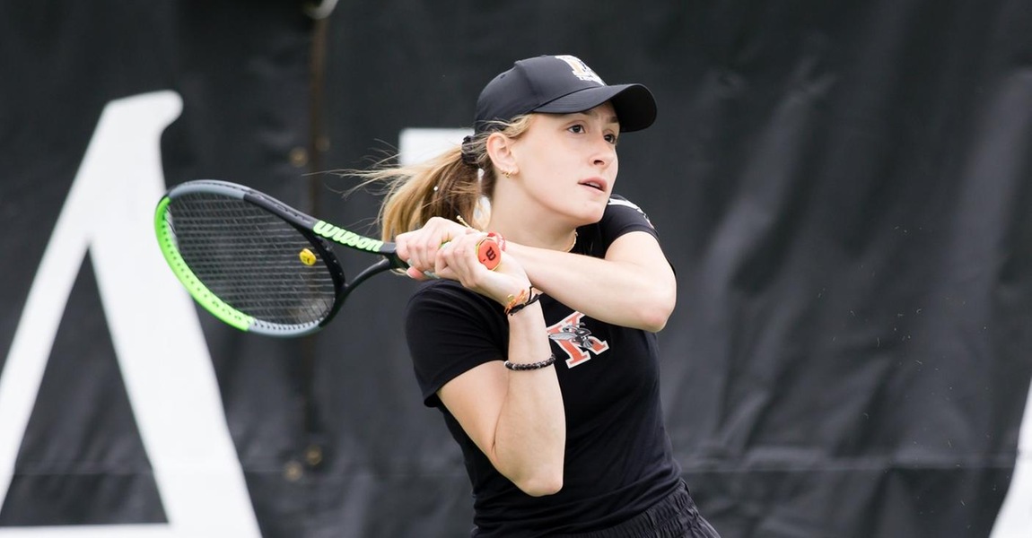 Helen Pelak playing tennis.